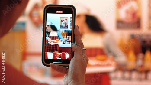 Happy customer record video of restaurant worker dancing and holding food tray at modern bar with food. Smart hispanic waitress preparing food order while customer hands holding camera. Regalement.