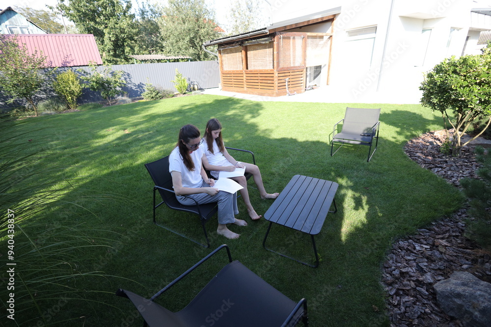 Mother and daughter having fun in the backyard Mother and daughter having fun in the backyard