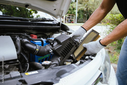 A technician in a workshop uses a wireless device to check a car's condition, updating a digital certificate. The scene highlights automotive repair, service, and efficiency in maintenance.