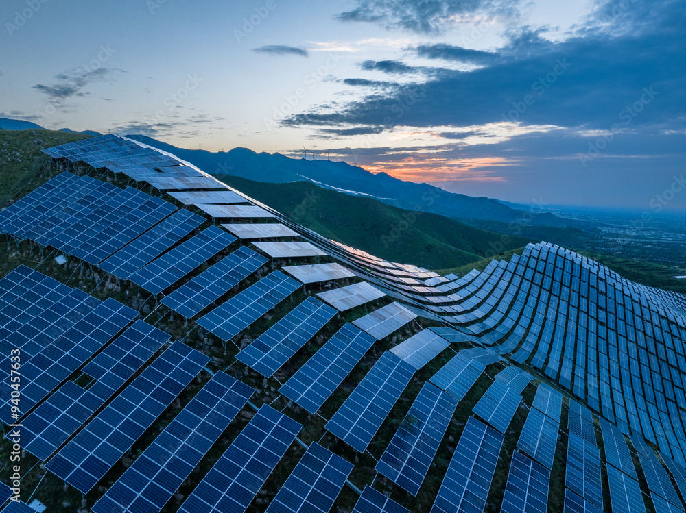 view of solar power station on hill at sunrise view of solar power station on hill at sunrise