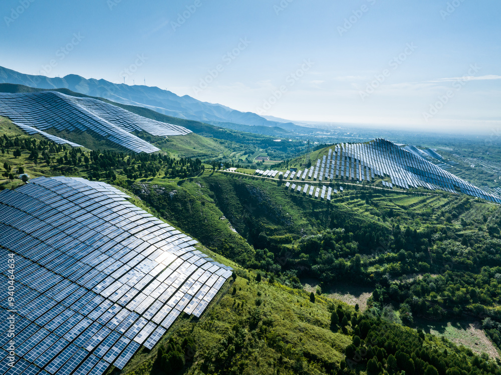 Fototapeta premium view of solar power station on green hill