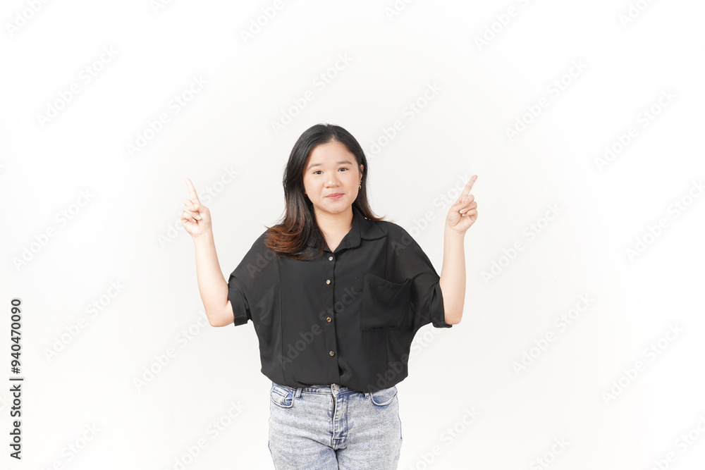 Young Asian woman showing product and pointing up copy space wearing Black t-shirt and jeans isolated on white background Young Asian woman showing product and pointing up copy space wearing Black t-shirt and jeans isolated on white background