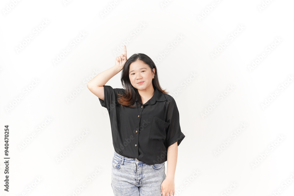 Young Asian woman showing product and pointing up copy space wearing Black t-shirt and jeans isolated on white background Young Asian woman showing product and pointing up copy space wearing Black t-shirt and jeans isolated on white background