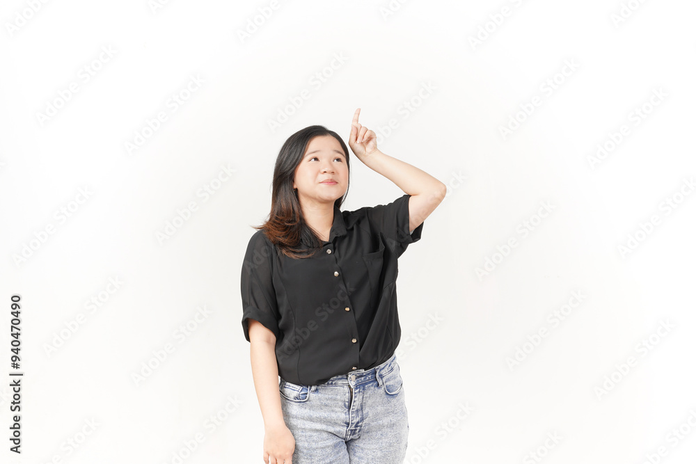 Young Asian woman showing product and pointing up copy space wearing Black t-shirt and jeans isolated on white background Young Asian woman showing product and pointing up copy space wearing Black t-shirt and jeans isolated on white background