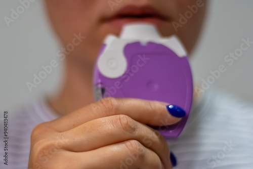 Wallpaper Mural Close up of woman holding medicine dry powder inhaler for treatment asthma or COPD diseases. Pharmaceutical product is used to treat lung inflammation and prevent asthma attack. High quality photo Torontodigital.ca