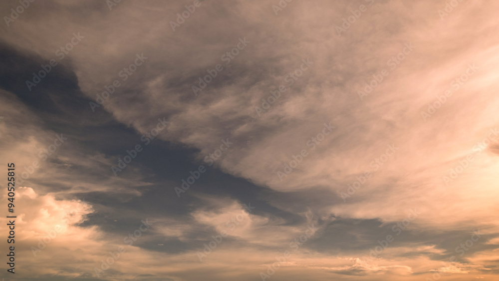 Naklejka premium Panoramic view of sunset golden and blue sky nature background. Colorful dramatic sky with cloud at sunset.Sky background.Sky with clouds at sunset.