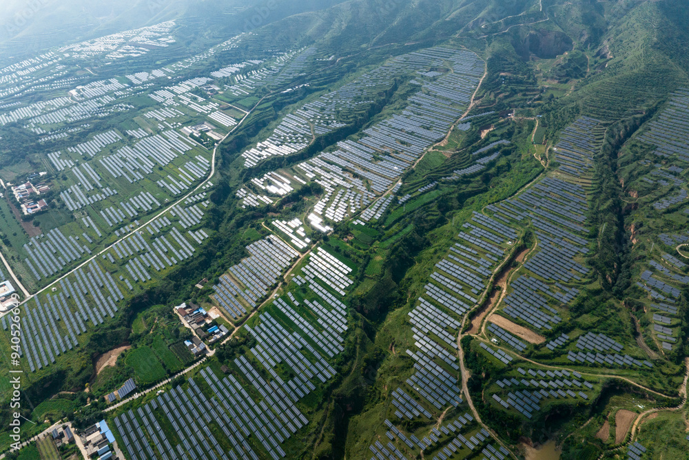 Fototapeta premium view of solar power station on green hill