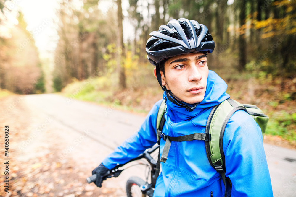Young man resting by bike in the middle of beautiful nature, early autumn morning. Concept of healthy lifestyle. Young man resting by bike in the middle of beautiful nature, early autumn morning. Concept of healthy lifestyle.