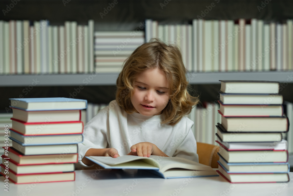 Serious school boy. School boy reading book in library. Kids development, learn to read. Pupil reading books in a book store. Serious school boy. School boy reading book in library. Kids development, learn to read. Pupil reading books in a book store.