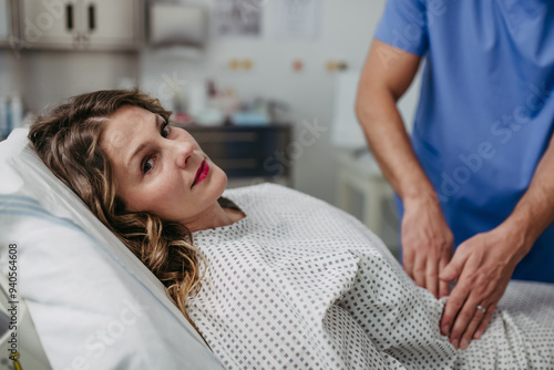 Bild auf Leinwand Doctor palpating woman's abdomen, using hands and steady pressure
