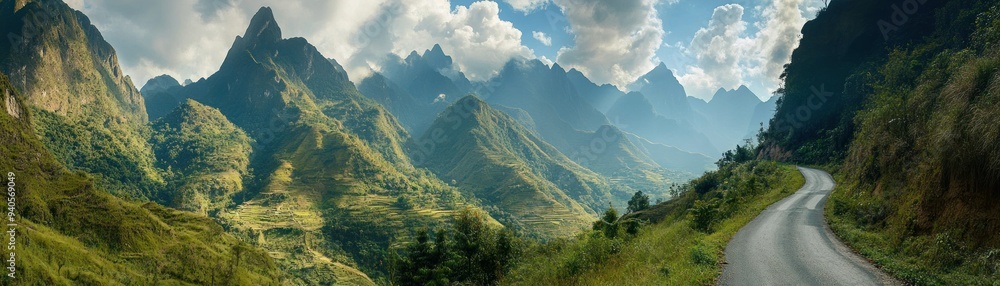 Naklejka premium Winding Road Through Lush Green Mountain Range