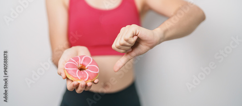 Wallpaper Mural woman hand hold Donut with tape measure, choose stop eating sweet is Unhealthy ealthy food. Dieting control, Weight loss, Obesity, eating lifestyle and nutrition concepts Torontodigital.ca