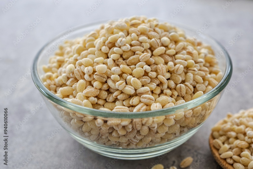 Barley rice in a glass cup on gray cement background Barley rice in a glass cup on gray cement background