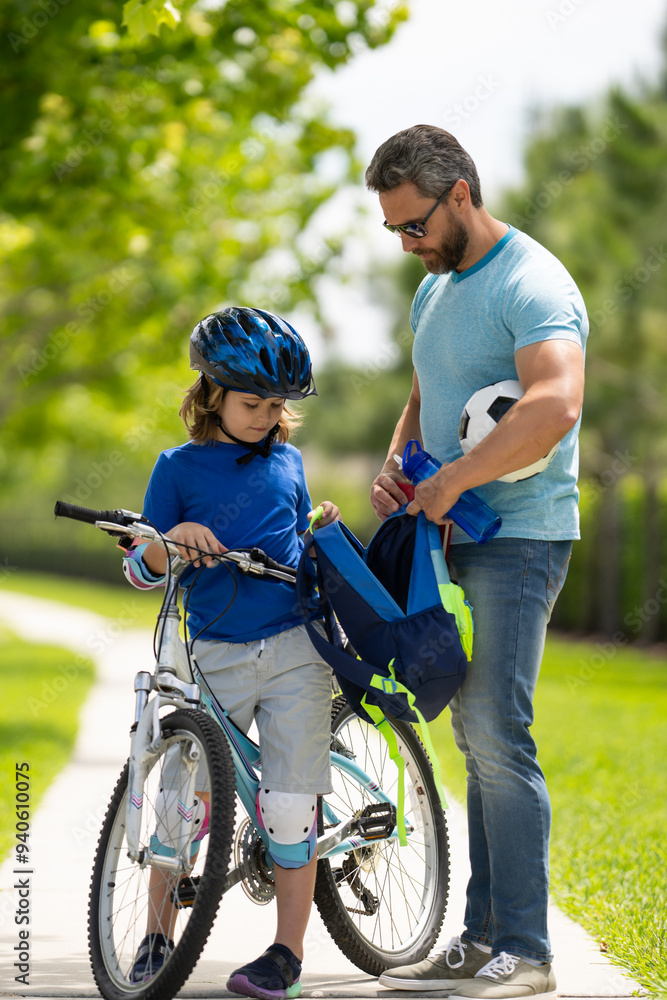 Fathers day. Father teaching son ride a bicycle. Father helping son get ready for school. Father playing with son outdoor. Father support child. Fathers love. Sporty kids. Fathers day. Father teaching son ride a bicycle. Father helping son get ready for school. Father playing with son outdoor. Father support child. Fathers love. Sporty kids.