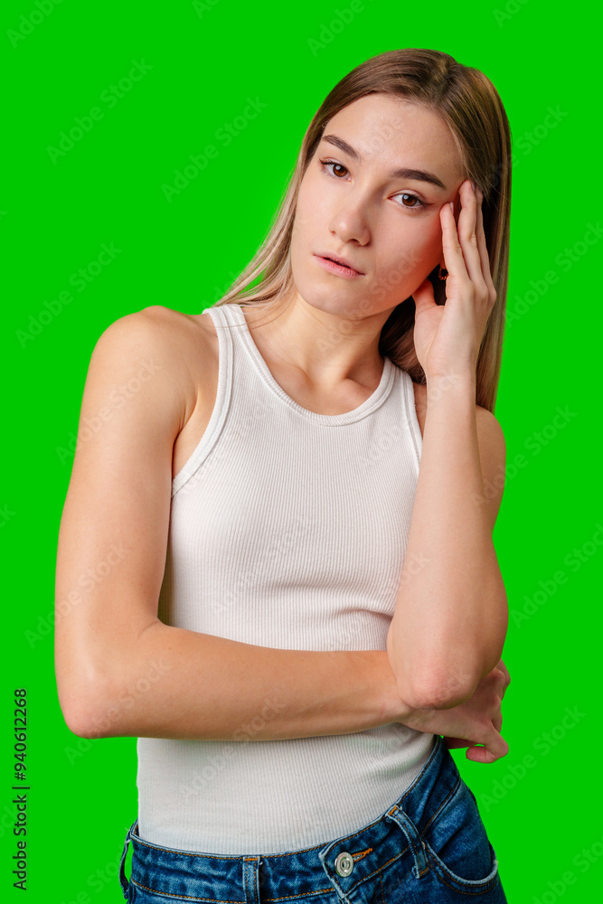 Young Woman Wearing White Tank Top and Jeans Against Green Screen Young Woman Wearing White Tank Top and Jeans Against Green Screen