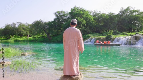 Omani man standing at Wadi Darbat Boating, salalah (Dhofar)