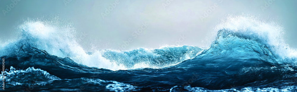Dynamic waves rise and fall, creating foam and splashes while reflecting shades of blue and gray in the calm early morning light Dynamic waves rise and fall, creating foam and splashes while reflecting shades of blue and gray in the calm early morning light