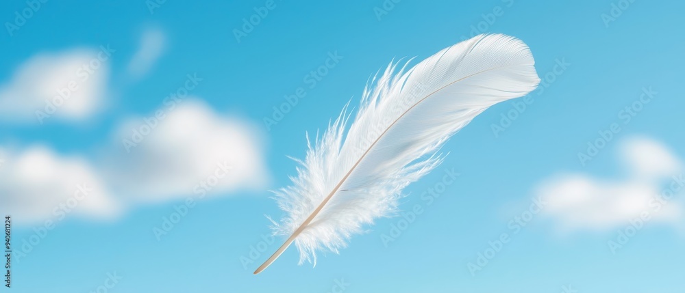 A white feather drifting against a blue sky with wispy white clouds as its backdrop A white feather drifting against a blue sky with wispy white clouds as its backdrop