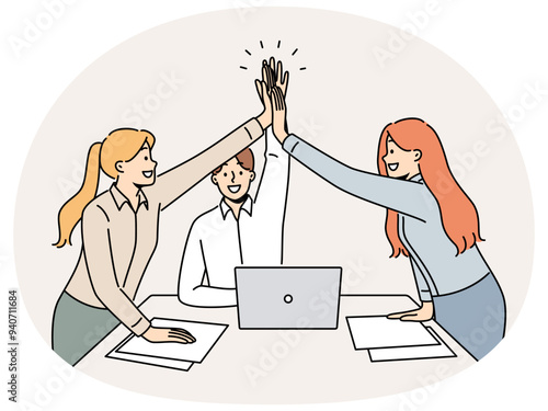 Successful business team rejoicing at completion of project, standing near office desk and giving high five to colleagues. Young successful paperwork clerks celebrating good performance