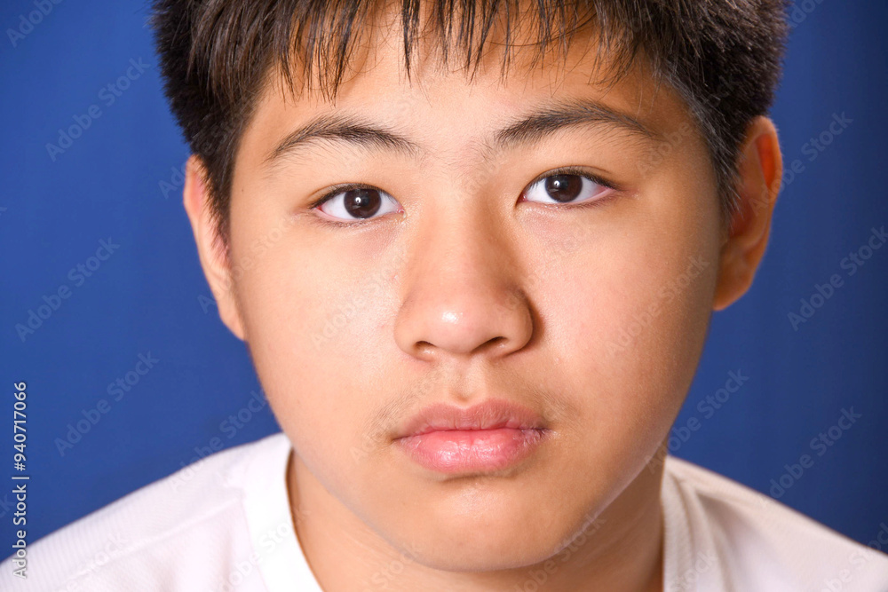 Close-up,Teenage boy on blue background. Close-up,Teenage boy on blue background.