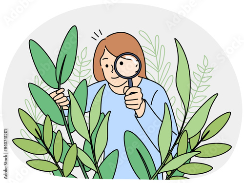 Woman botanist with magnifier look at plants