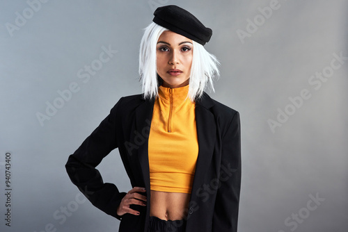 Fashion, portrait and serious with woman in studio isolated on gray background for casual or trendy style. Clothes, confident and outfit with confident hipster person in clothing to model wardrobe