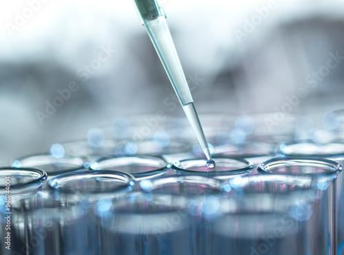 Liquid samples extracted from test tube using pipette in laboratory