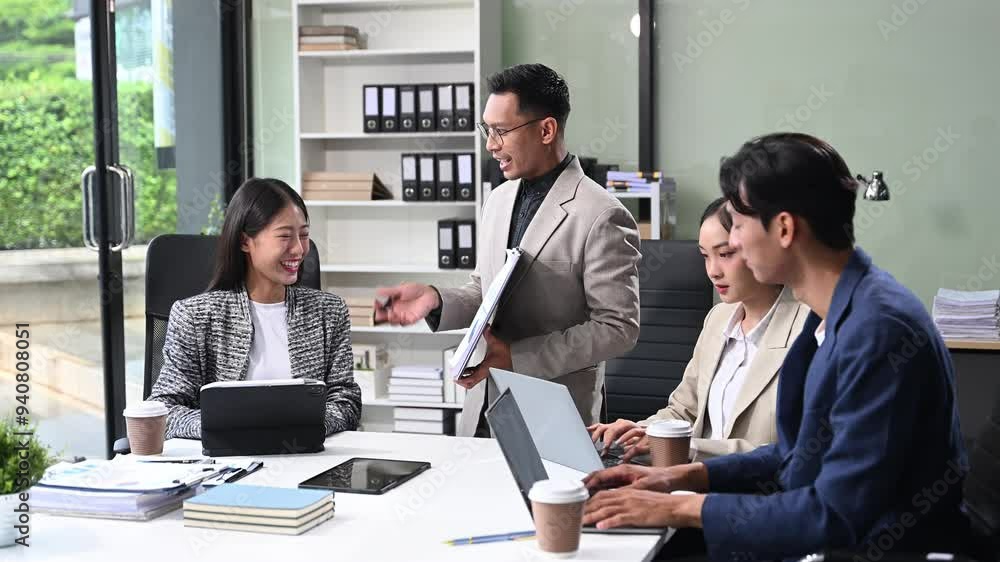 Office colleagues have a casual discussion. During a meeting in a conference room, a group of business teem sit in the conference room Office colleagues have a casual discussion. During a meeting in a conference room, a group of business teem sit in the conference room