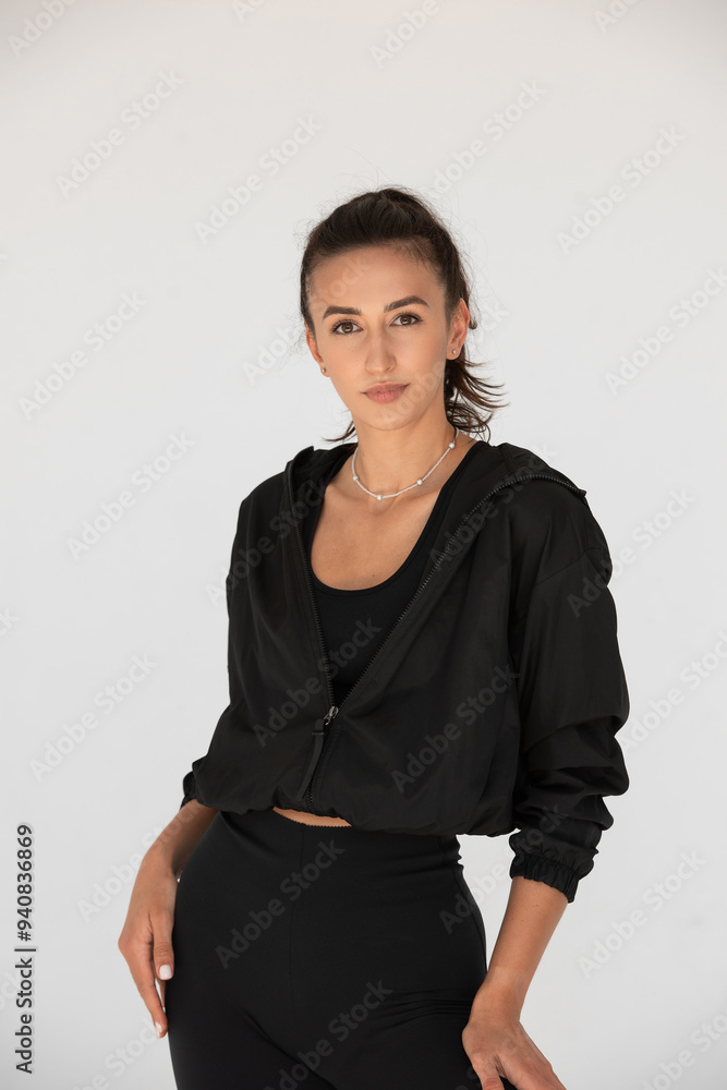 Young athlete girl posing in a black leggings and shirt. indoors Young athlete girl posing in a black leggings and shirt. indoors