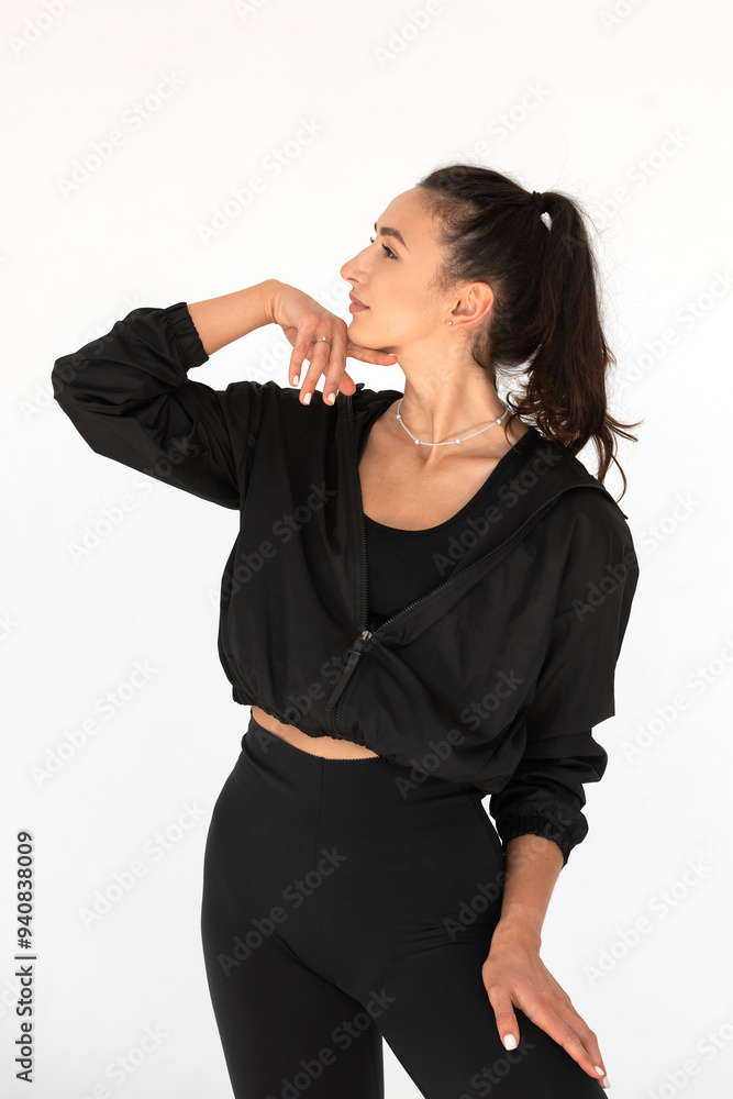 Young athlete girl posing in a black leggings and shirt. indoors Young athlete girl posing in a black leggings and shirt. indoors