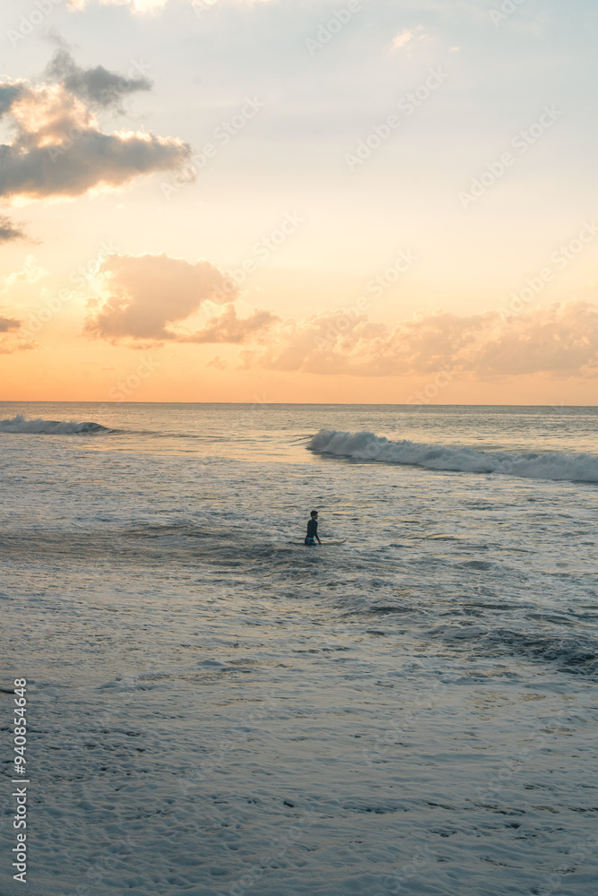 People running on the beach in Bali, Indonesia at sunrise People running on the beach in Bali, Indonesia at sunrise