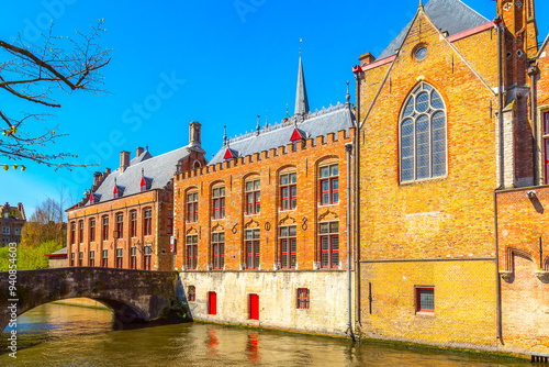 Canal, boat, tourists in Bruges, Belgium photo