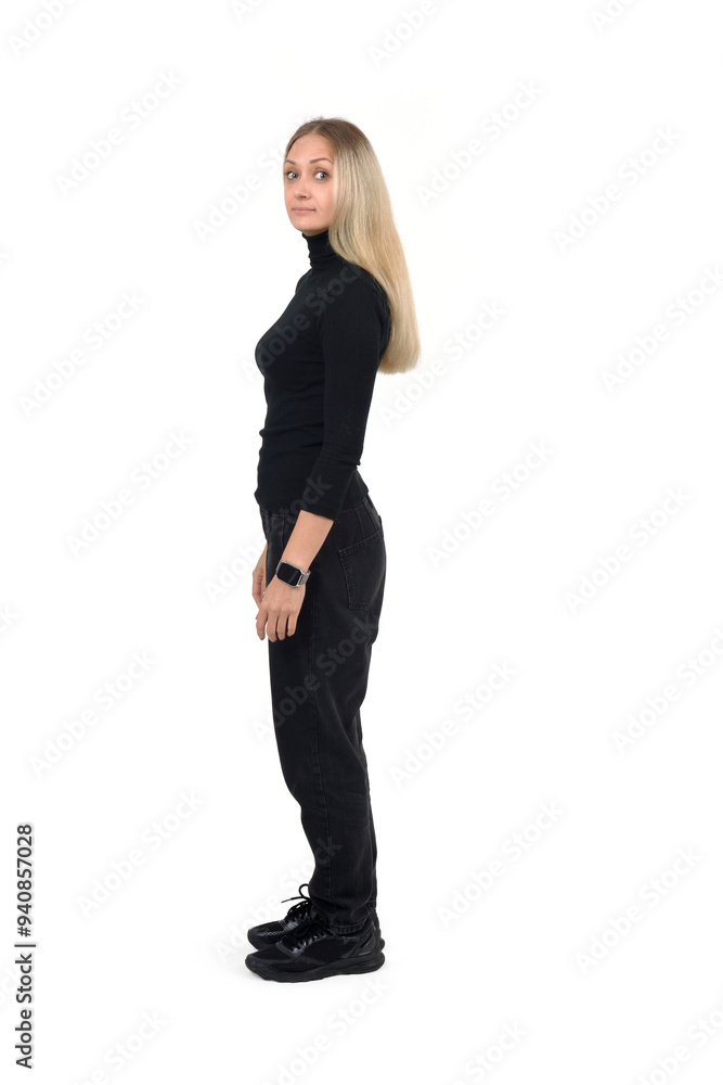 side view of serious woman standing and lookig at camera on white background side view of serious woman standing and lookig at camera on white background
