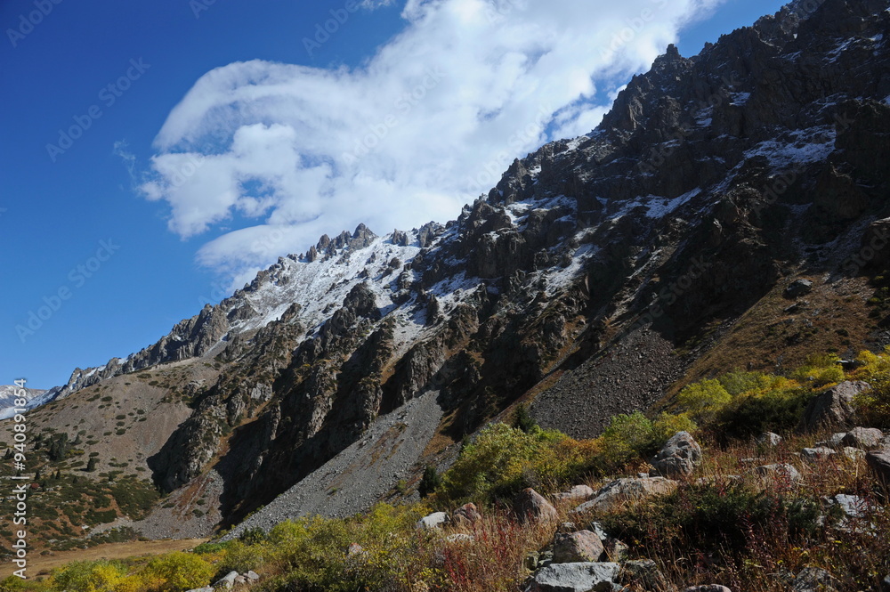 Mountains with large rocky slopes and vegetation. Mountains with large rocky slopes and vegetation.