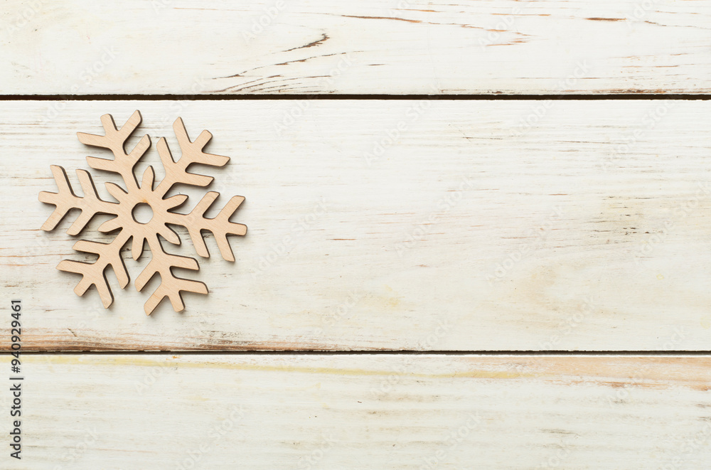 Beautiful snowflake on woden background, top view Beautiful snowflake on woden background, top view