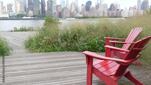 New York City waterfront skyline, Manhattan Midtown buildings, riverfront skyscrapers by East river water. Waterside cityscape view, Gantry Plaza Park, Long Island, Queens. United States. Chair bench. photo