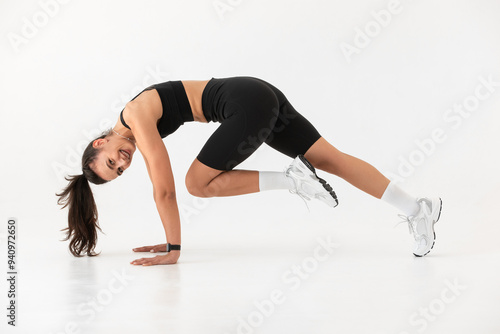 Smiling healthy woman doing yoga at home. white background