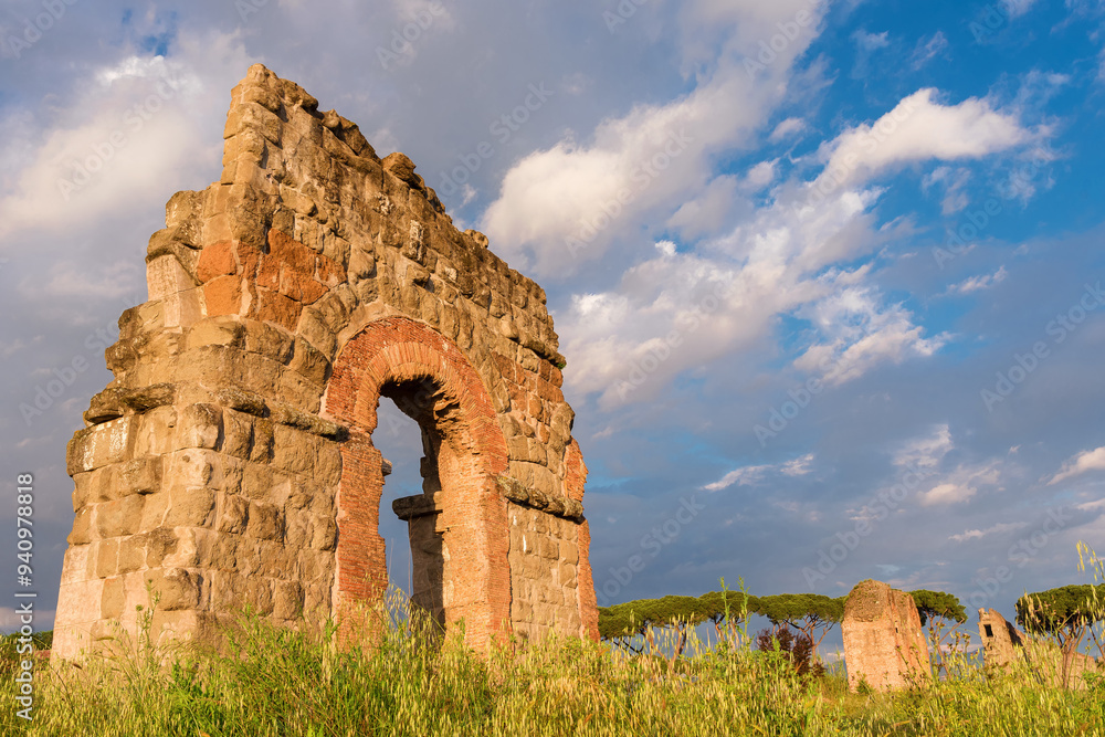 Ancient roman aqueduct beautiful arches ruins in Rome public park with beautiful clouds Ancient roman aqueduct beautiful arches ruins in Rome public park with beautiful clouds