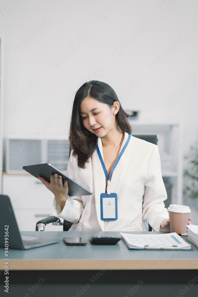 successful business women hand working with tablet and laptop computer with documents on office desk in modern office. successful business women hand working with tablet and laptop computer with documents on office desk in modern office.