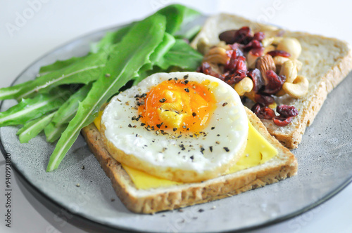 bread with egg and cheese topping or sunny side up egg , lettuce and almond with dried cranberry