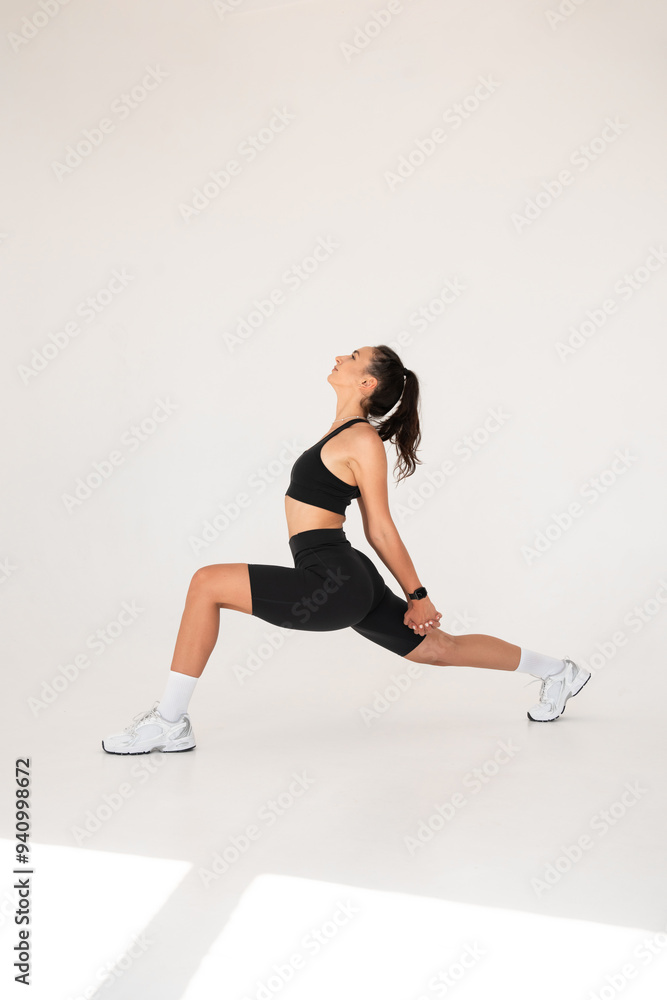 Fototapeta premium Smiling healthy woman doing yoga at home. white background