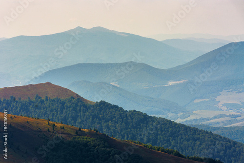 scenery with rolling slopes of borzhava ridge. scenic carpathian mountain landscape in dappled light. view in to the distant valley of transcarpathia in late summer photo