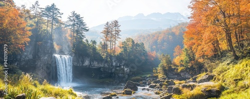 A waterfall surrounded by vibrant autumn foliage, with sunlight filtering through the trees, capturing nature s beauty in fall Journey Autumn Vacation, Waterfall Wonder photo