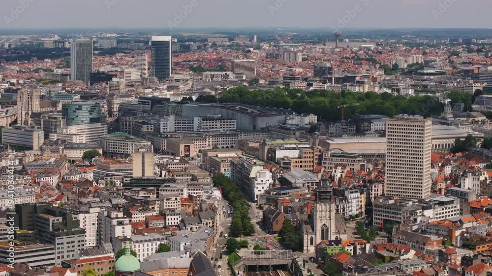 Camera pans across the Brussels cityscape, showcasing a dense collection of modern and classic buildings and landmarks Camera pans across the Brussels cityscape, showcasing a dense collection of modern and classic buildings and landmarks