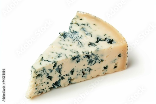 A close-up view of a wedge of blue cheese with greenish marbling on a white background