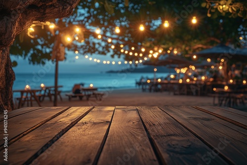 Empty wooden table with blurred beach bar at night