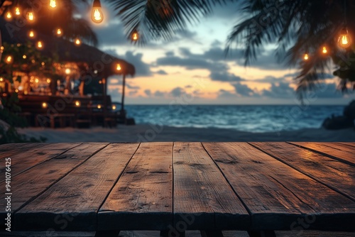 Empty wooden table with blurred beach bar at night