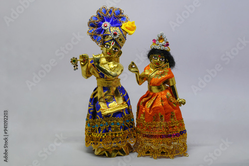 Idol of Goddess Devi Radha and Lord Krishna made of brass, isolated on a white background.  photo