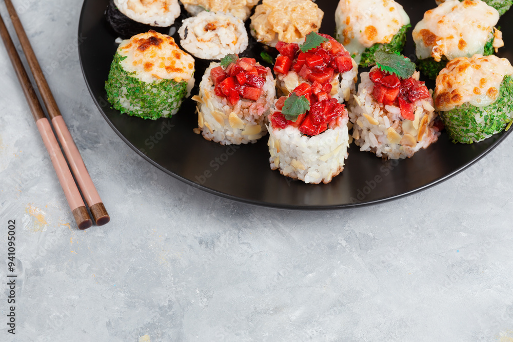 Assorted Sushi Rolls On Black Plate With Chopsticks Assorted Sushi Rolls On Black Plate With Chopsticks