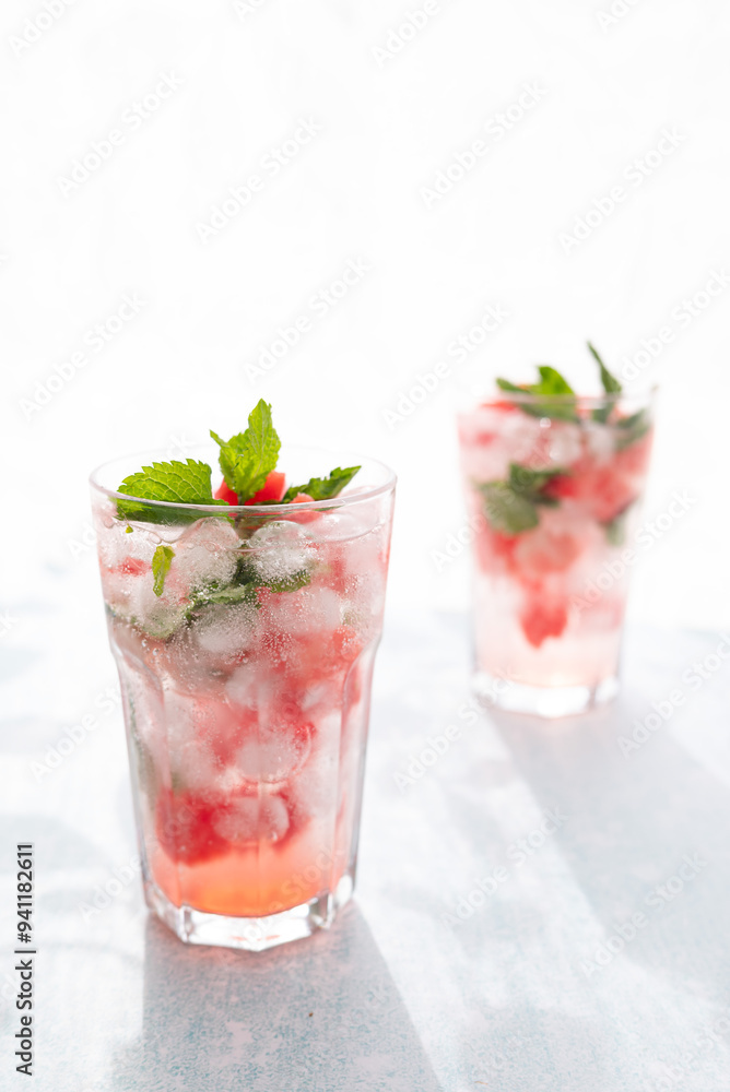 Homemade summer watermelon lemonade with ice and mint on light background, place for text Homemade summer watermelon lemonade with ice and mint on light background, place for text
